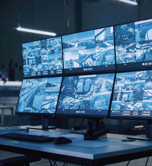 CCTV Digital Monitoring & Surveillance Systems Multiple surveillance monitors displaying live security camera footage in a control room setup.