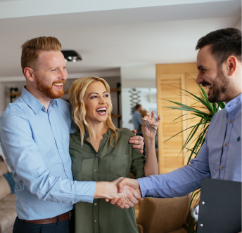 Proven Client Satisfaction Happy couple shaking hands with a professional after receiving house keys, symbolizing client satisfaction.